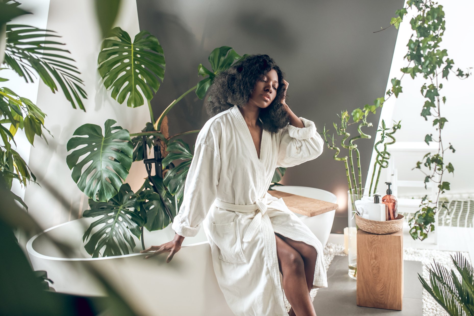 Woman Wearing Robe in a Tropical Bathroom